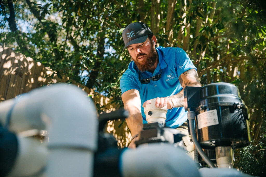 A man in blue t-shirt inspecting water with machineries